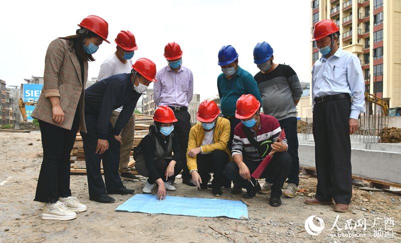 4月17日，一群建设者们在复工复产后的广西宁明县城中镇第三小学教学综合楼项目建设工地上进行建设工程质量安全监督抽查。周贻刚摄